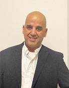 A person smiling for the camera  Description automatically generated with medium confidence